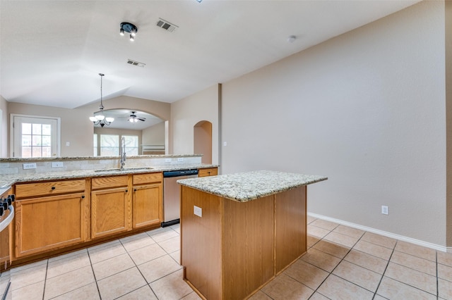 1117 Red Hawk Dr, Frisco, TX 75033 - kitchen featuring stainless steel appliances, a sink, lofted ceiling, light stone countertops, and arched walkways
