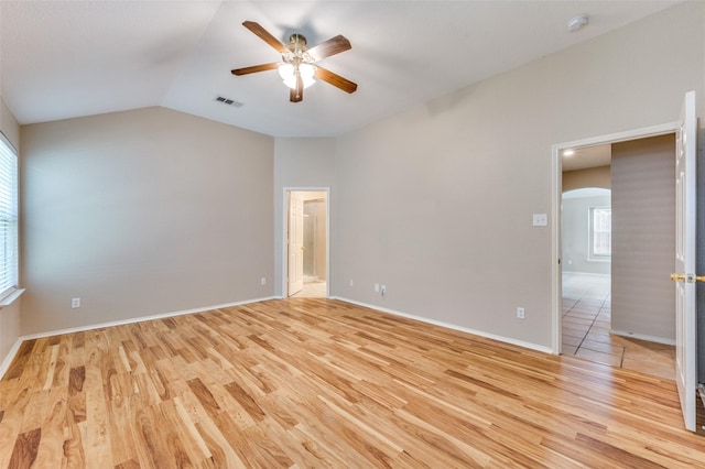 1117 Red Hawk Dr, Frisco, TX 75033 - unfurnished room with a ceiling fan, light wood-type flooring, arched walkways, vaulted ceiling, and baseboards