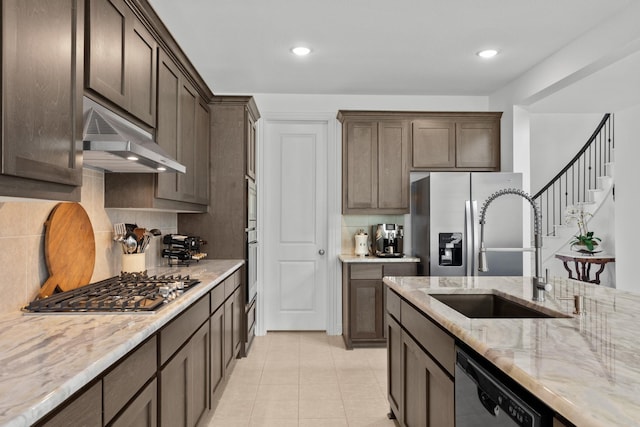 2788 Walker Way, Northlake, TX 76247 - kitchen featuring under cabinet range hood, a sink, stainless steel appliances, dark brown cabinetry, and decorative backsplash