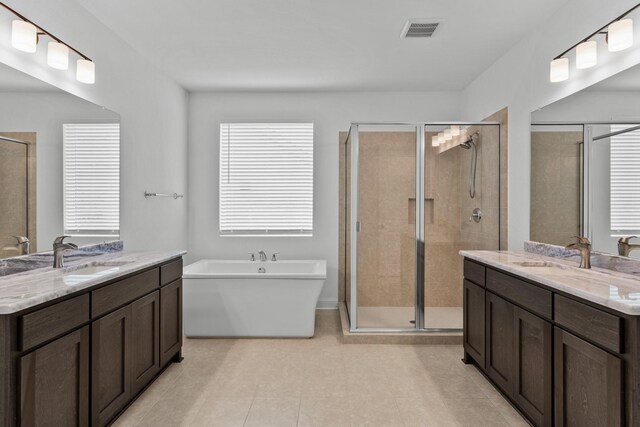2788 Walker Way, Northlake, TX 76247 - full bath with two vanities, a shower stall, a freestanding bath, and tile patterned floors