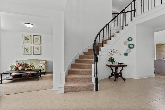 2788 Walker Way, Northlake, TX 76247 - staircase featuring a towering ceiling, baseboards, tile patterned flooring, and carpet flooring