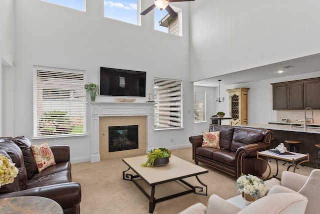 2788 Walker Way, Northlake, TX 76247 - living room with a towering ceiling, ceiling fan, light carpet, a tiled fireplace, and baseboards