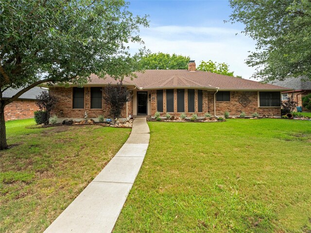 211 Indian Trace Ln, Waxahachie, TX 75165 - ranch-style home featuring brick siding, a chimney, and a front lawn