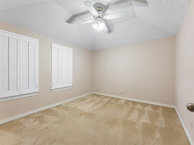 211 Indian Trace Ln, Waxahachie, TX 75165 - empty room featuring carpet, a textured ceiling, a ceiling fan, baseboards, and lofted ceiling