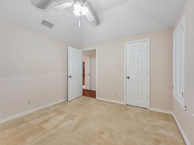 211 Indian Trace Ln, Waxahachie, TX 75165 - unfurnished bedroom with a textured ceiling, light carpet, baseboards, and a ceiling fan