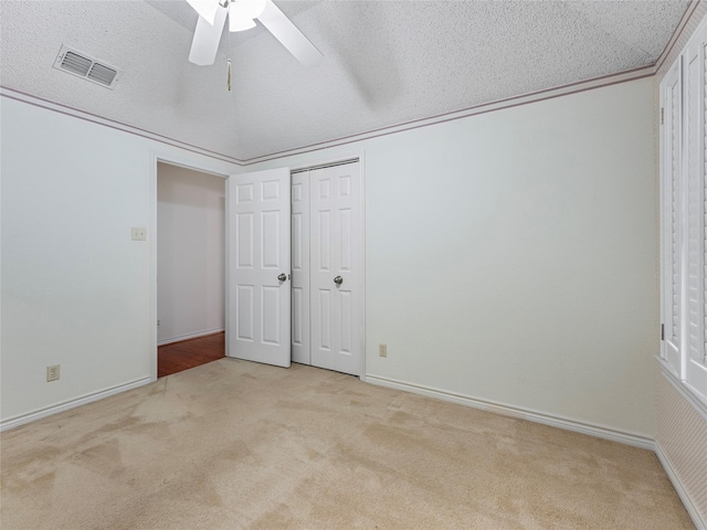 211 Indian Trace Ln, Waxahachie, TX 75165 - unfurnished bedroom with carpet flooring, baseboards, a ceiling fan, a closet, and a textured ceiling