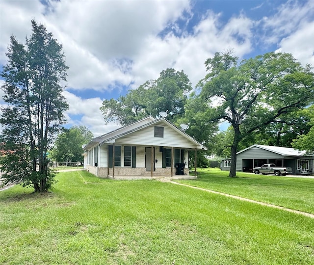 601 Elm St, Teague, TX 75860 - view of front of property with a porch, a front lawn, and brick siding