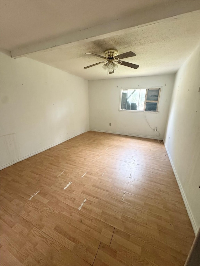 601 Elm St, Teague, TX 75860 - empty room featuring light wood-style flooring, a ceiling fan, baseboards, and a textured ceiling