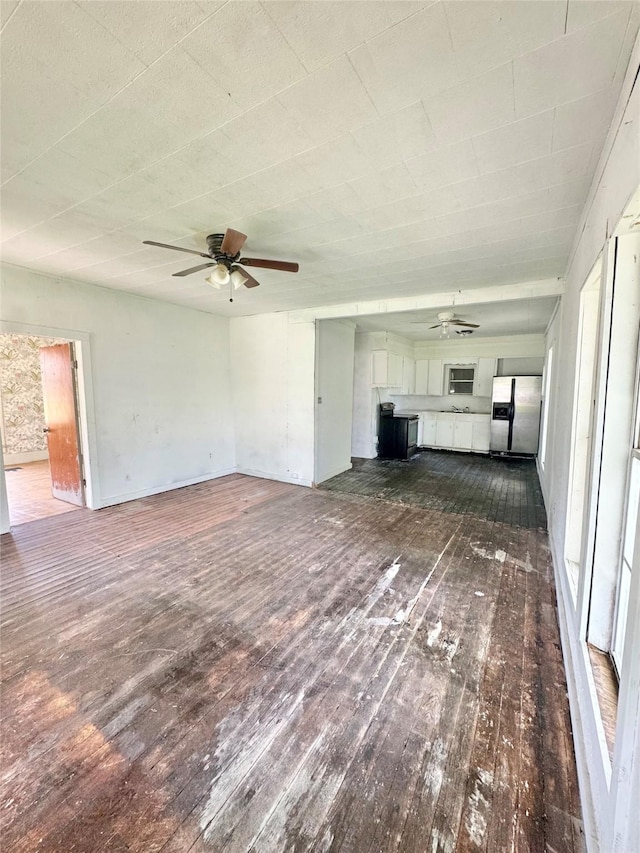 601 Elm St, Teague, TX 75860 - unfurnished living room with a ceiling fan and dark wood-type flooring