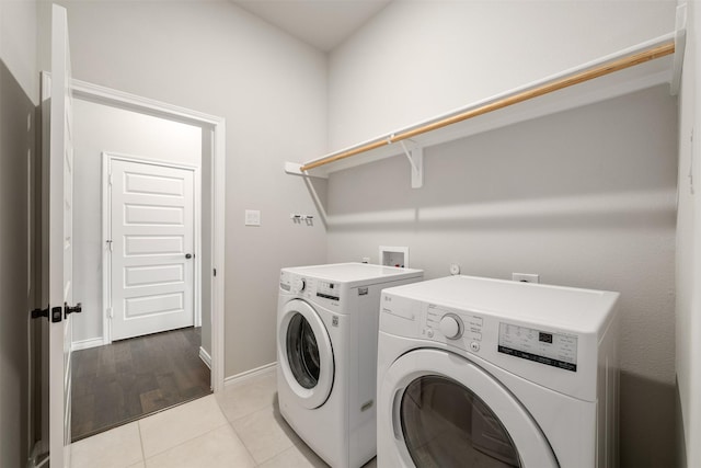 2627 Askern Ct, Grand Prairie, TX 75052 - washroom featuring washer and dryer, baseboards, and light tile patterned floors