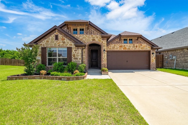 2627 Askern Ct, Grand Prairie, TX 75052 - french country home with a garage, concrete driveway, stone siding, and brick siding
