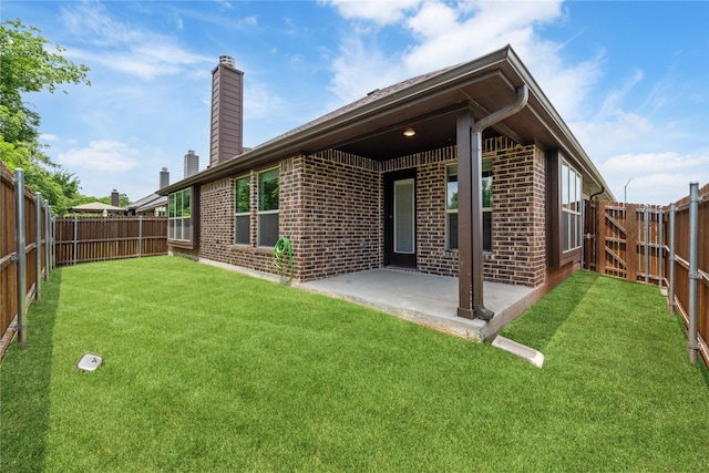 2627 Askern Ct, Grand Prairie, TX 75052 - rear view of house with a chimney, brick siding, and a patio