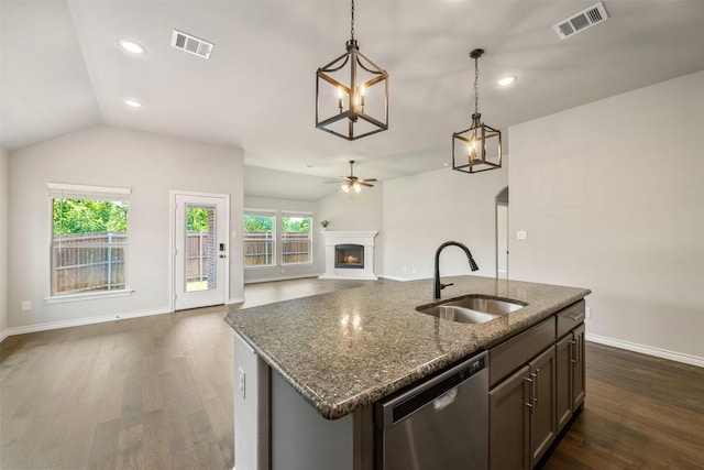 2627 Askern Ct, Grand Prairie, TX 75052 - kitchen with stainless steel dishwasher, a sink, open floor plan, a ceiling fan, and a lit fireplace