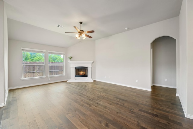2627 Askern Ct, Grand Prairie, TX 75052 - unfurnished living room with arched walkways, dark wood-type flooring, ceiling fan, and baseboards