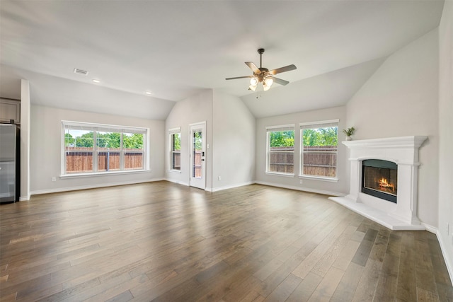 2627 Askern Ct, Grand Prairie, TX 75052 - unfurnished living room featuring lofted ceiling, a ceiling fan, a warm lit fireplace, dark wood-type flooring, and baseboards