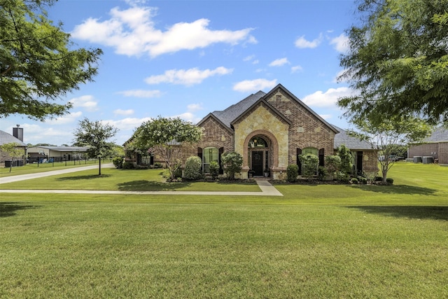 217 Silver Rose Blvd, Burleson, TX 76028 - view of front facade with a front yard, stone siding, and brick siding