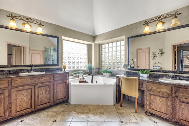 217 Silver Rose Blvd, Burleson, TX 76028 - bathroom with two vanities, a bath, and tile patterned floors