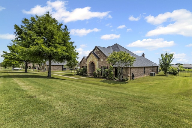 217 Silver Rose Blvd, Burleson, TX 76028 - view of side of home with stone siding, a chimney, and central AC unit