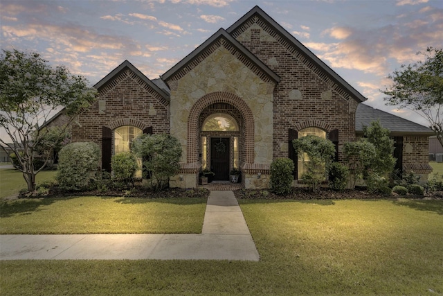 217 Silver Rose Blvd, Burleson, TX 76028 - view of front facade with brick siding, stone siding, a lawn, and a shingled roof