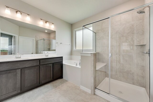 616 Juneau St, Gainesville, TX 76240 - bathroom featuring a stall shower, a garden tub, double vanity, and tile patterned flooring