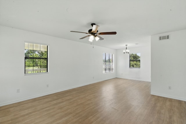 11720 Lavender Ave, Azle, TX 76020 - empty room featuring a chandelier, a ceiling fan, and light wood-style floors