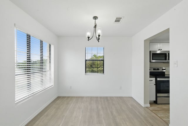 11720 Lavender Ave, Azle, TX 76020 - unfurnished dining area featuring light wood-style floors, a chandelier, and baseboards