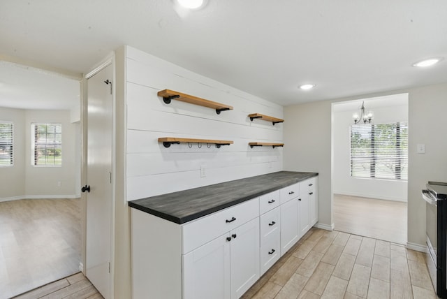 11720 Lavender Ave, Azle, TX 76020 - kitchen with dark countertops, open shelves, light wood finished floors, plenty of natural light, and recessed lighting