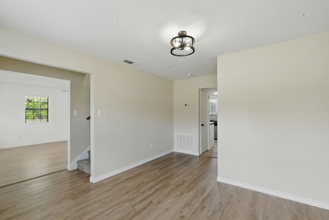 11720 Lavender Ave, Azle, TX 76020 - empty room featuring light wood finished floors, stairs, and baseboards