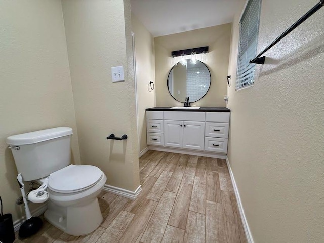 11720 Lavender Ave, Azle, TX 76020 - bathroom featuring wood finished floors, vanity, and a textured wall