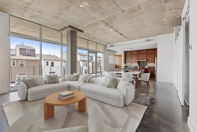 3030 Bryan St Unit 310, Dallas, TX 75204 - living room featuring rail lighting and concrete flooring