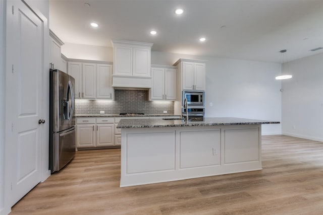 928 Marian Dr, Allen, TX 75013 - kitchen with appliances with stainless steel finishes, stone countertops, backsplash, white cabinetry, and a sink