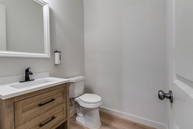 928 Marian Dr, Allen, TX 75013 - bathroom featuring toilet, wood finished floors, baseboards, and vanity