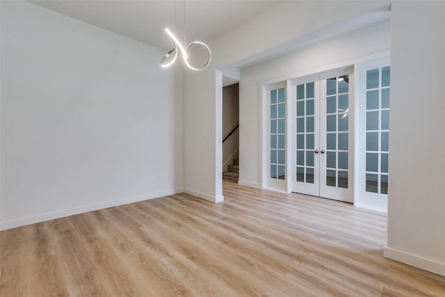 928 Marian Dr, Allen, TX 75013 - spare room featuring light wood-style floors, baseboards, and french doors