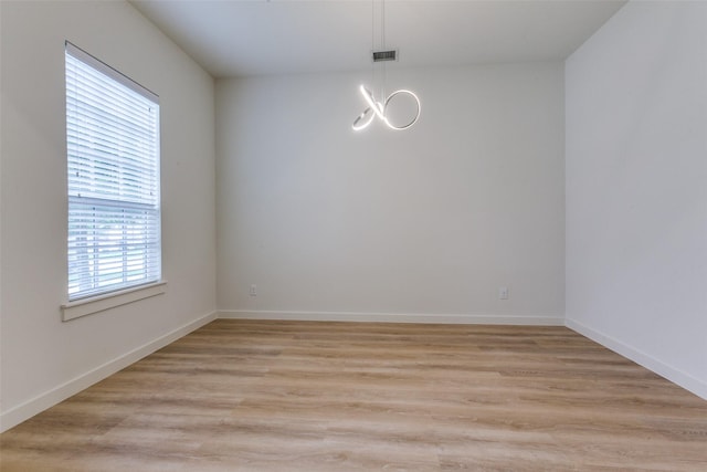 928 Marian Dr, Allen, TX 75013 - unfurnished room with a chandelier, light wood-style floors, and baseboards
