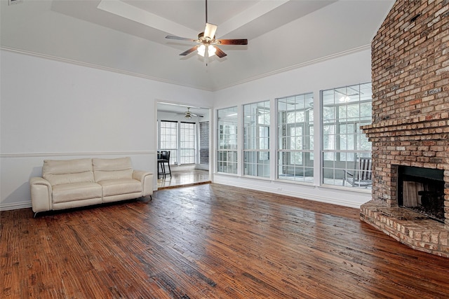 3308 Corn Valley Rd, Grand Prairie, TX 75052 - unfurnished living room featuring ceiling fan, wood finished floors, a brick fireplace, and baseboards