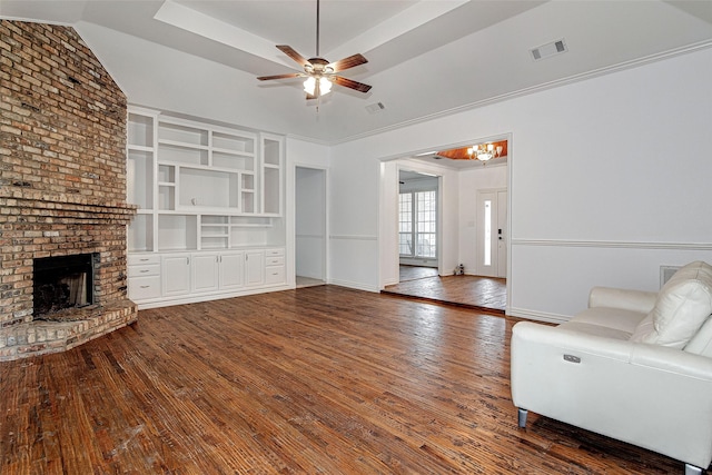 3308 Corn Valley Rd, Grand Prairie, TX 75052 - unfurnished living room with wood-type flooring, ceiling fan, a fireplace, and a chandelier