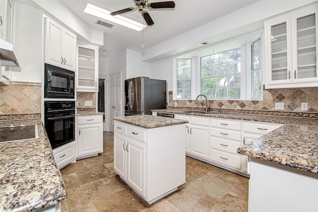 3308 Corn Valley Rd, Grand Prairie, TX 75052 - kitchen featuring black appliances, decorative backsplash, ceiling fan, and white cabinetry