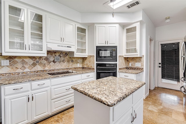 3308 Corn Valley Rd, Grand Prairie, TX 75052 - kitchen featuring black appliances, under cabinet range hood, white cabinetry, and light stone counters