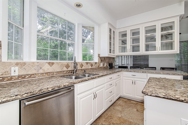 3308 Corn Valley Rd, Grand Prairie, TX 75052 - kitchen with stainless steel dishwasher, a sink, backsplash, and glass insert cabinets