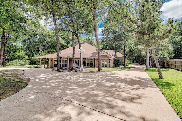 3308 Corn Valley Rd, Grand Prairie, TX 75052 - single story home featuring concrete driveway and view of wooded area