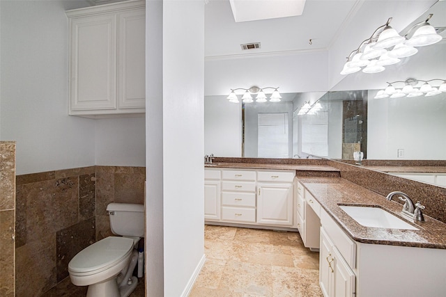 3308 Corn Valley Rd, Grand Prairie, TX 75052 - full bath with double vanity, toilet, tile walls, a skylight, and crown molding