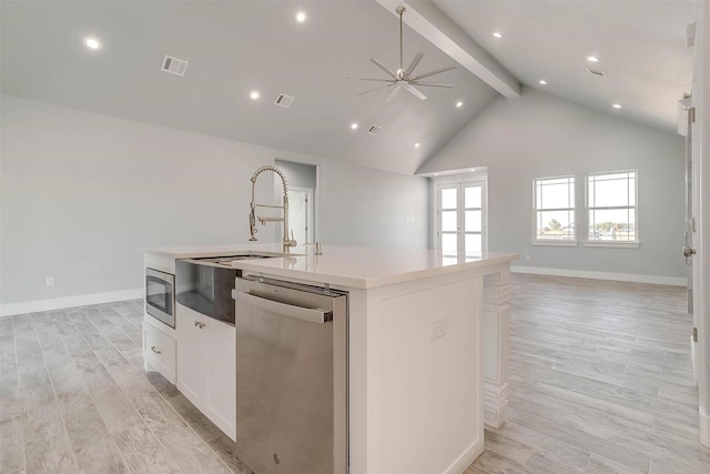 580 Highview Ct, Godley, TX 76044 - kitchen with stainless steel appliances, open floor plan, beam ceiling, a kitchen island with sink, and white cabinetry