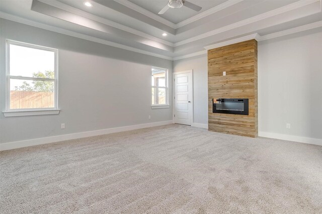 580 Highview Ct, Godley, TX 76044 - unfurnished living room with ornamental molding, a tray ceiling, carpet, a ceiling fan, and a fireplace
