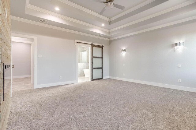 580 Highview Ct, Godley, TX 76044 - empty room featuring a barn door, light colored carpet, a tray ceiling, ornamental molding, and baseboards