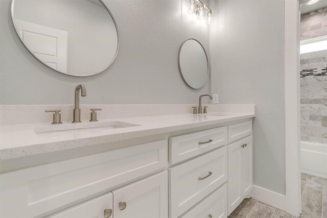 580 Highview Ct, Godley, TX 76044 - bathroom featuring double vanity,  shower combination, and baseboards