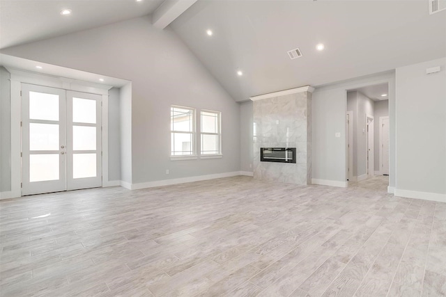 580 Highview Ct, Godley, TX 76044 - unfurnished living room featuring beam ceiling, light wood-style floors, recessed lighting, a high end fireplace, and french doors