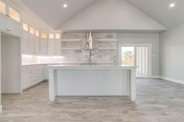 580 Highview Ct, Godley, TX 76044 - kitchen featuring open shelves, vaulted ceiling, light countertops, white cabinetry, and tasteful backsplash