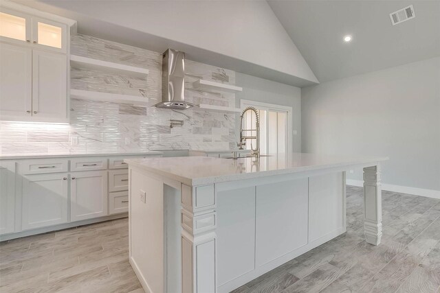 580 Highview Ct, Godley, TX 76044 - kitchen featuring wall chimney exhaust hood, light countertops, a sink, decorative backsplash, and light wood-type flooring