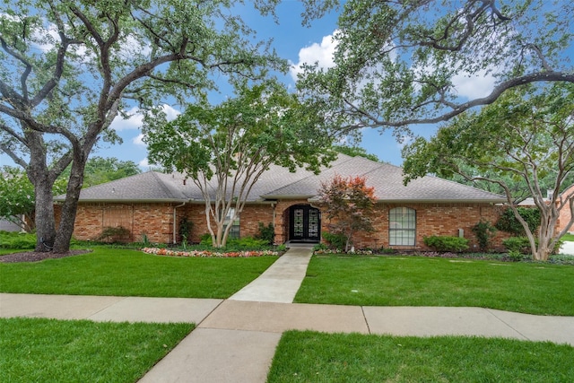 2021 Wing Point Ln, Plano, TX 75093 - view of front facade with french doors, a front lawn, brick siding, and roof with shingles