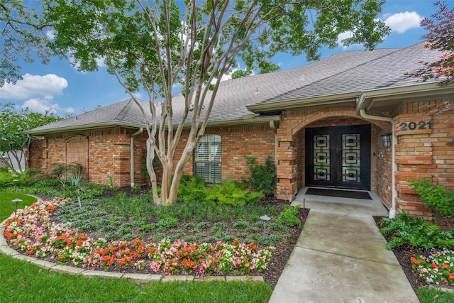 2021 Wing Point Ln, Plano, TX 75093 - view of exterior entry featuring brick siding and roof with shingles